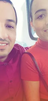 Portrait of smiling individuals in red tones, ideal for warm mobile wallpaper.