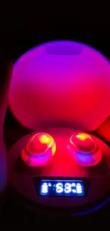 Mobile wallpaper of glowing earbud dock in red and purple.