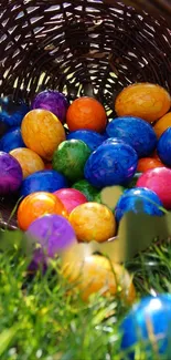 Vibrant Easter eggs scattered on green grass from a wicker basket.