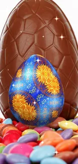 Vibrant blue and yellow Easter egg with chocolate, surrounded by colorful candies.