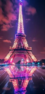 Eiffel Tower at night with vibrant purple reflection.