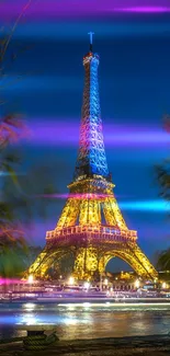 Eiffel Tower at night with vibrant neon lights and a royal blue sky.