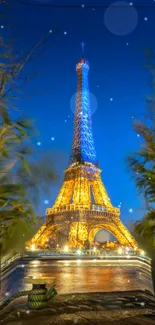 Eiffel Tower illuminated at night in Paris with vibrant blue and golden hues.