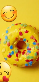 Bright yellow donut with emojis and colorful sprinkles.