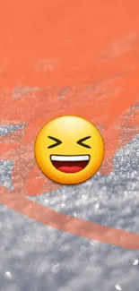 Laughing emoji on snowy background with orange hue.