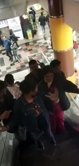 Group of people on a vibrant mall escalator.