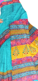 Colorful turquoise saree with pink and yellow patterns.