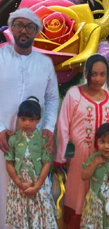 Family in traditional attire with vibrant floral background.