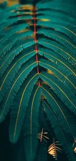 Vibrant teal fern leaf with red accents for mobile wallpaper.