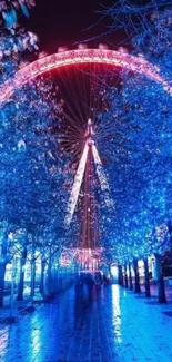 Stunning night view of a Ferris wheel illuminated in vibrant blue and pink lights.