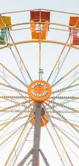 Vibrant Ferris wheel against a clear sky.