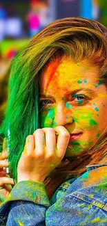 Vibrant paint festival wallpaper featuring colorful splashes on a smiling woman.