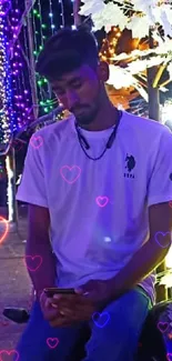 Man on bike amidst vibrant festival lights at night.