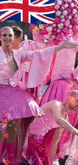 Festive parade with pink costumes and a Union Jack flag.