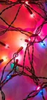 Vibrant festive lights on dark wires creating a colorful pattern.