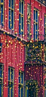 Vibrant red building lit with festive golden string lights.