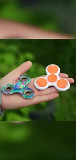 Colorful fidget spinners on a green background.