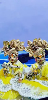 Two golden figurines with ornate designs and yellow highlights.