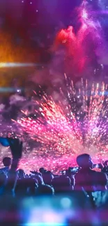 Vibrant fireworks explode over a lively outdoor concert with a cheering crowd.