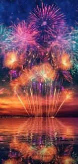 Vibrant fireworks reflecting over a calm ocean at night.