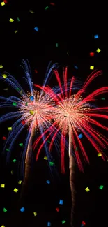 Vibrant fireworks in red and blue against a dark sky.