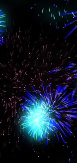 Blue and green fireworks illuminating the night sky in a colorful display.