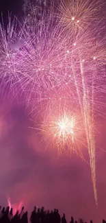 Vibrant purple fireworks illuminating a night sky.