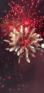 Vibrant red fireworks lighting up the night sky.