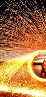 Vibrant fireworks display with orange sparks in the night sky.