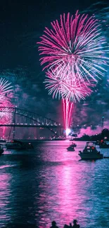 Fireworks burst over a bridge with reflections on the water at night.