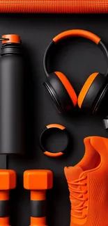 Orange fitness gear neatly arranged on a dark background.