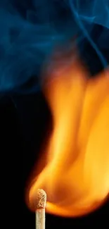 Matchstick with vibrant flame and blue smoke on black background.