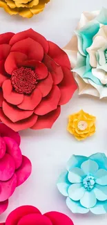 Vibrant paper flower art with red, turquoise, and pink hues.