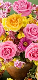 Floral wallpaper with pink and yellow roses in vibrant arrangement.