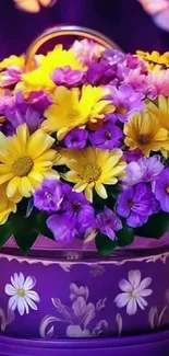 Vibrant floral bouquet in a purple decorative vase with yellow and purple flowers.