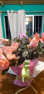 Vibrant pink flower bouquet with green leaves.