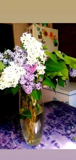 Vibrant lilac and white floral bouquet in a glass vase.