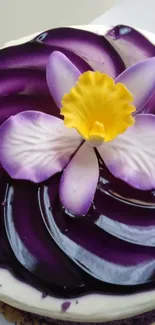 Vibrant violet flower cake with yellow center design.