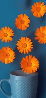 Blue cup with vibrant orange flowers wallpaper.