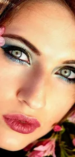 Close-up portrait of a woman with floral accents and vibrant eye makeup.