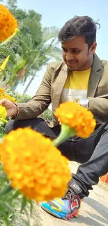 Man enjoying a vibrant flower garden with colorful marigolds.