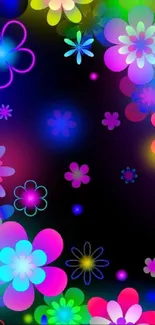 Bright neon flowers glow against a dark background in this vibrant mobile wallpaper.