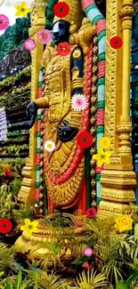 Golden statue surrounded by colorful flowers.