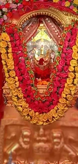 Sacred idol adorned with colorful floral garlands and vibrant decorations.