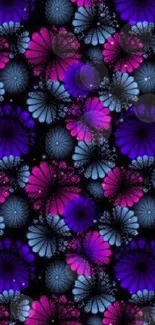 Vibrant floral wallpaper with pink and blue flowers on a black background.