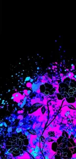 Neon floral design with pink and blue splashes on a black background.