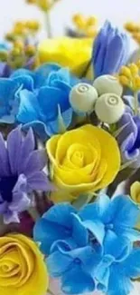 Vibrant floral wallpaper with bright blue and yellow flowers in a stunning bouquet.