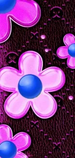 Pink flowers with blue centers on a dark textured background.