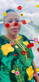 Woman in green dress with floating flowers in vibrant wallpaper.