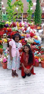 Two girls in a colorful flower shop with vibrant floral display.